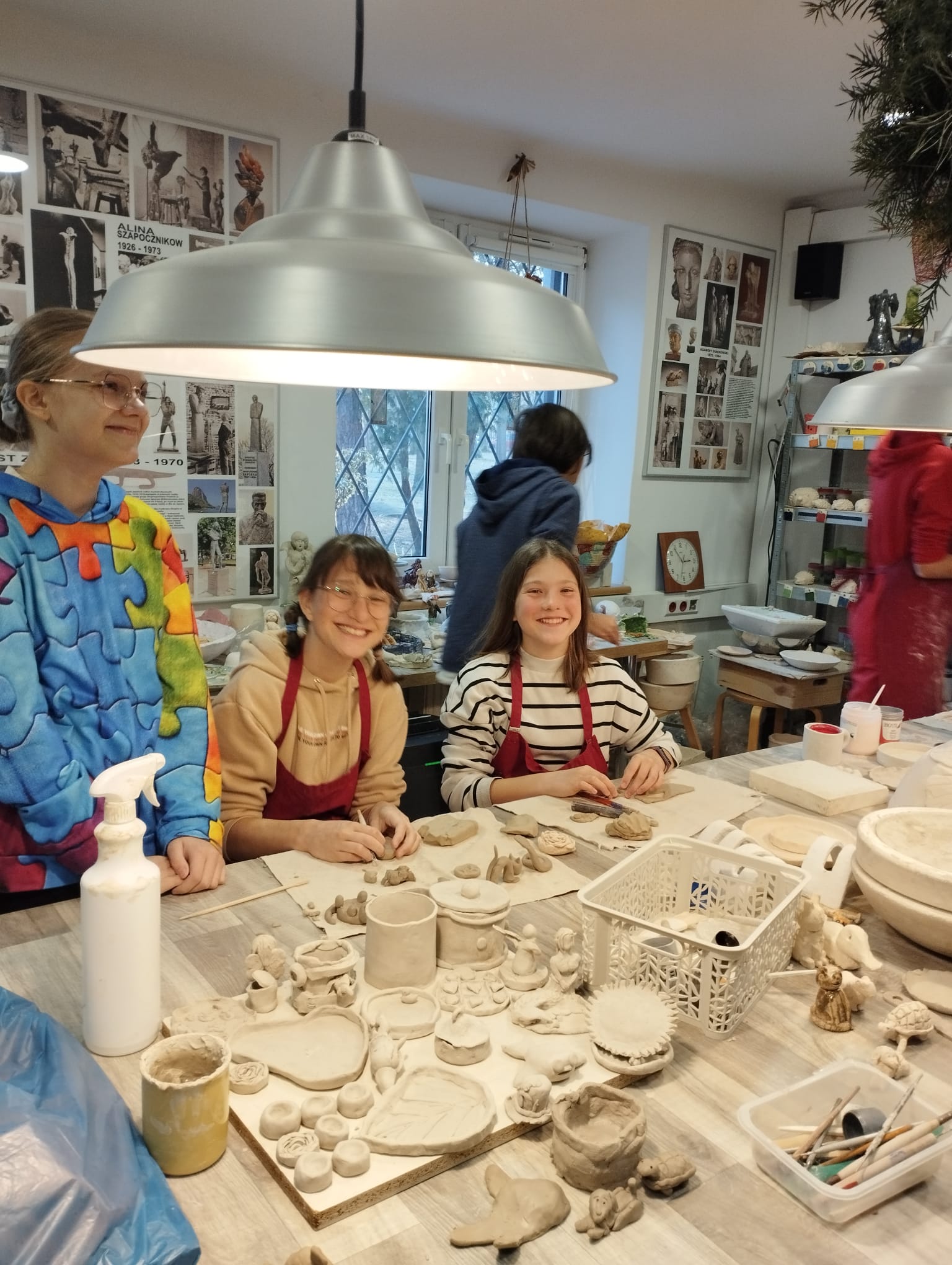 DZIECI ZA STOŁEM W PRACOWNI CERAMICZNEJ